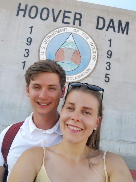 I&B's Founder & Husband posing in front of the Hoover Dam sign