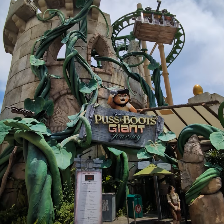 Entrance to a themed attraction featuring giant vines and a playful character.