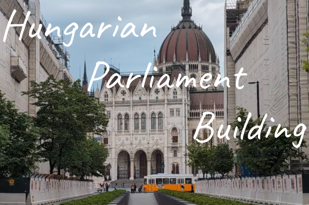 Hungarian Parliament Building with a grand dome, framed by trees and a pathway.
