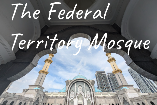 View of the Federal Territory Mosque in Kuala Lumpur featuring ornate architecture and tall minarets.