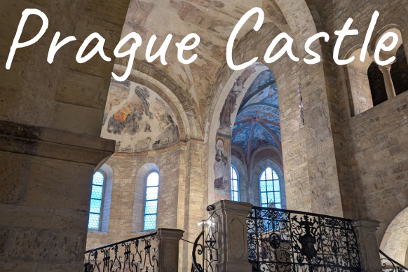 Interior view of Prague Castle showcasing arches and decorative windows.