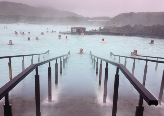 Blue Lagoon in Iceland, an outdoor geothermally heated pool with people bathing in misty, blue water.