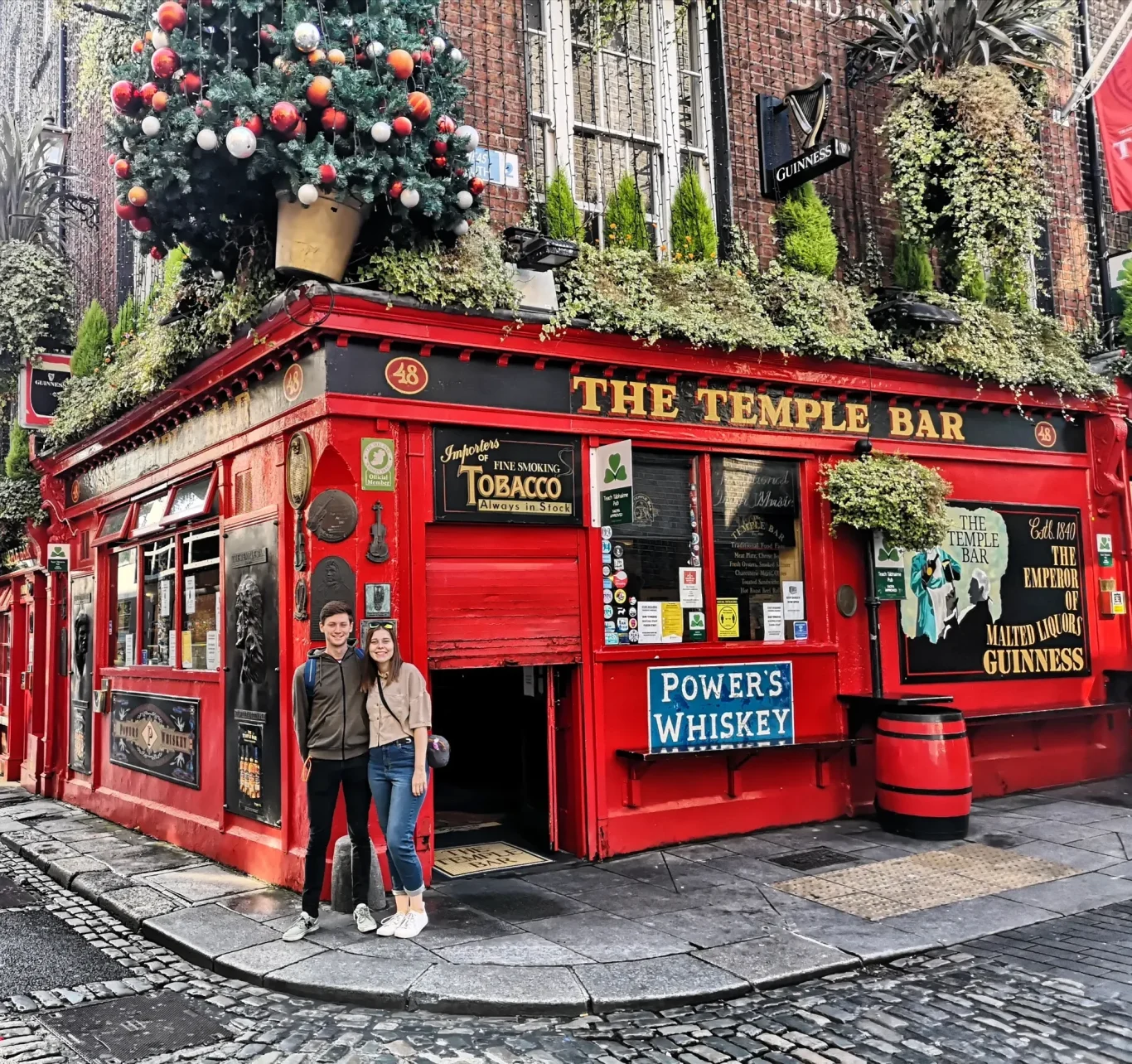 I&B's Founder and Husband posing in front of the iconic red building of Temple Bar in Dublin