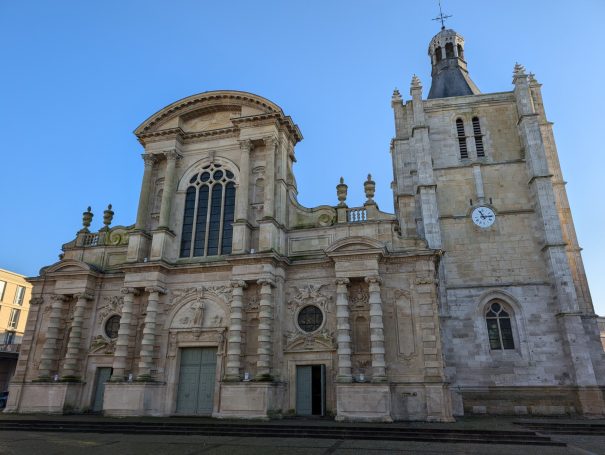 Le Havre Cathedral, an historic stone church with tall clock tower and intricate architectural details.