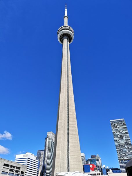 The CN Tower stands tall against a clear blue sky in Toronto.