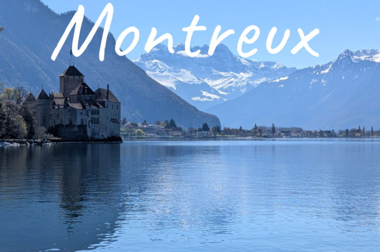 Scenic view of Montreux, featuring mountains and a lake with a castle.