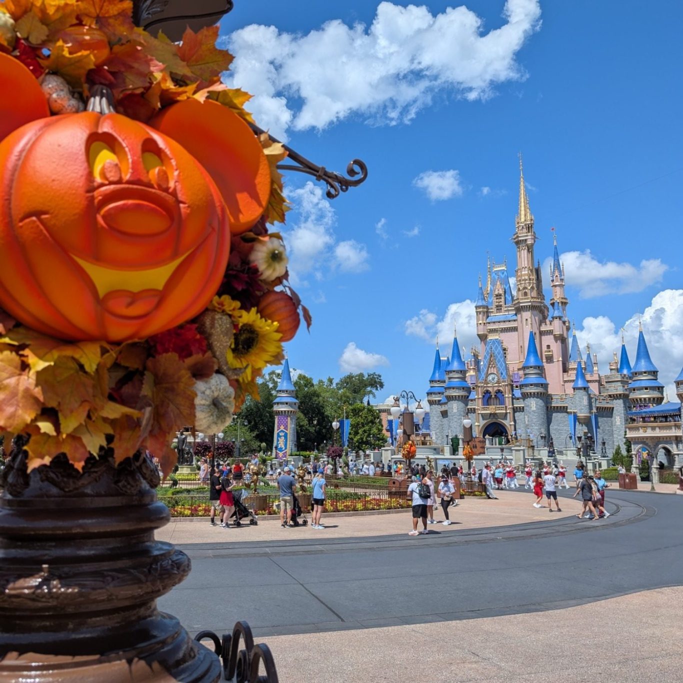 Mickey Mouse Halloween decoration with a grinning pumpkin in front of the Cinderella castle at Magic Kingdom.