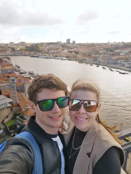 I&B's Founder & Husband posing with the Porto cityscape and Douro River in the background