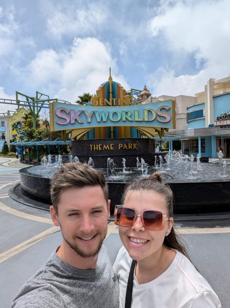 I&B's Founder & Husband posing in front of the SkyWorlds Theme Park Sign