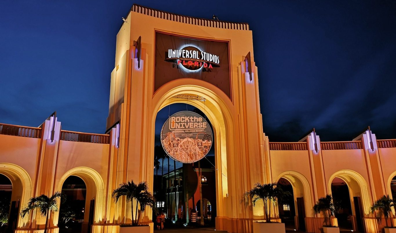 Hard Rock Cafe entrance at night, featuring vibrant lights and palm trees.