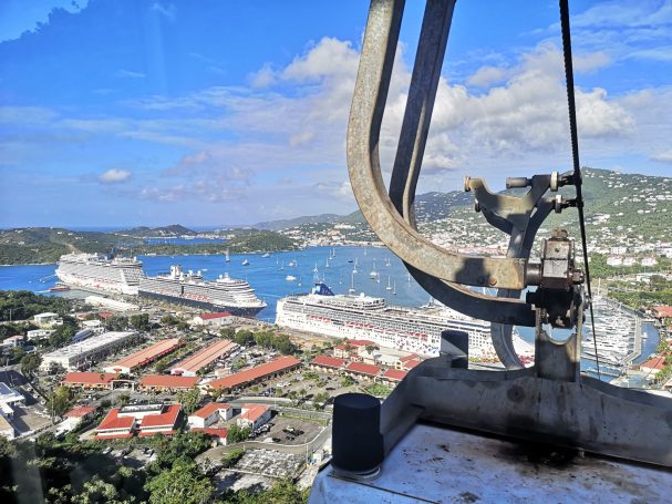 View from a high vantage point overlooking a harbour with cruise ships and coastal buildings.