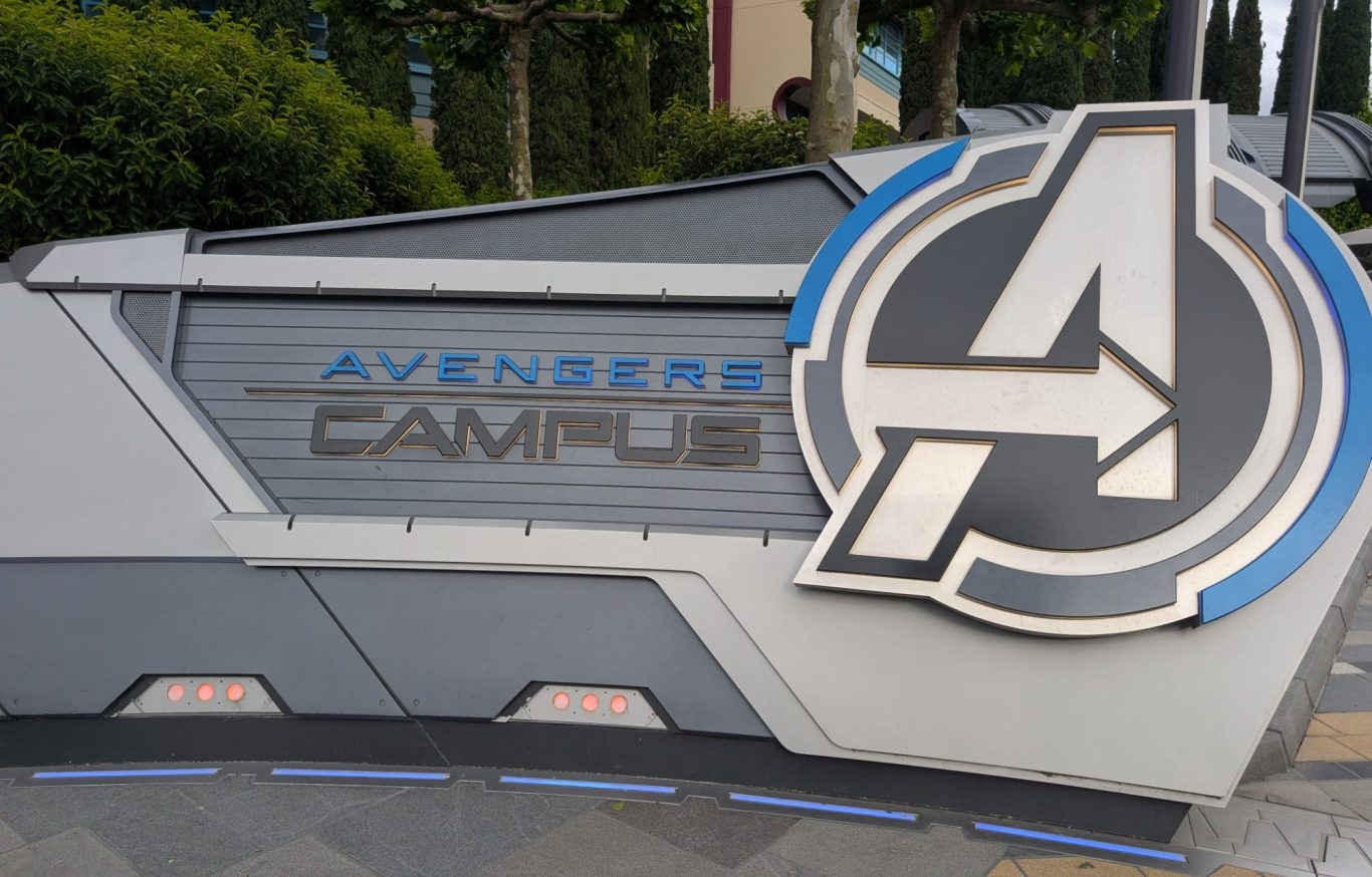 Sign for Avengers Campus featuring the iconic Avengers logo and title.