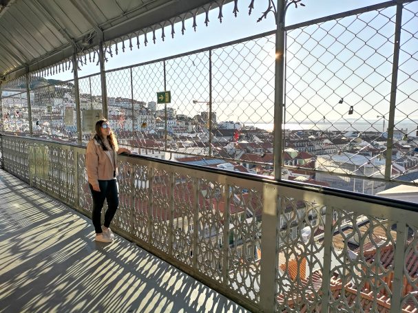 I&B's Founder posing at the top of the Santa Justa Lift with the Lisbon city views in the background.