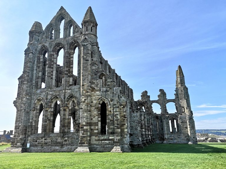 Whitby Abbey against a blue sky.